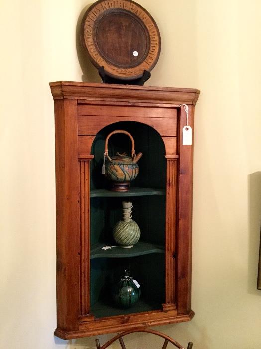 Pine corner cabinet with studio pottery.