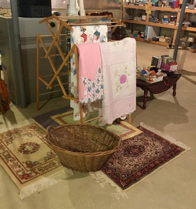 Cutter quilts, rugs, basket and rack.