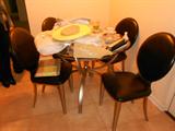 Glass/Stainless Dining Table with 4 black leather chairs, glass top table