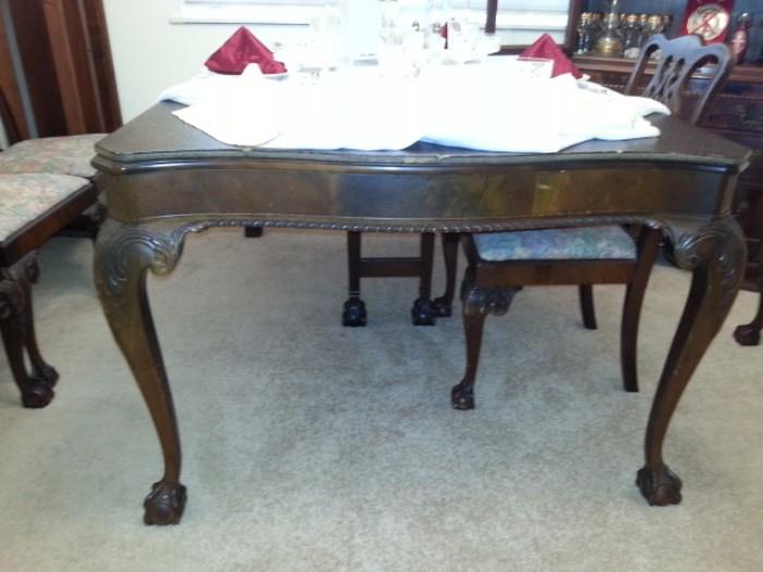 Solid Mahogany table with two leaves and custom pads, English Chippendale style with Cabriole legs ball and claw feet, hand carved in the 1940's.  Matching hutch with three drawers.