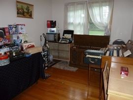 Organ, Stereo cabinet with 8 track player and turn table, organ, sewing machine with cabinet, vacumm, LP's, accordian, Bookcase with Glass sliding doors
