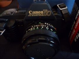 The Canon T70 was a 35mm FD-mount single-lens reflex camera introduced in April 1984 as the second in Canon's T series. The T70 started with the concepts explored in 1983's T50, took them further, and applied them to a more sophisticated camera. While the Program AE-only T50 was intended as a beginner's camera, the T70 gave the photographer a lot more control over the camera's operation while keeping the T-series philosophy of simplicity in control and operation intact