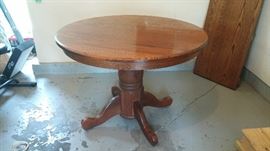 Solid oak four pedestal kitchen/dining table with leaf and four chairs