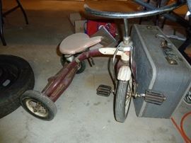Vintage tricycle and suitcase