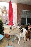 Outdoor table with umbrella and chairs