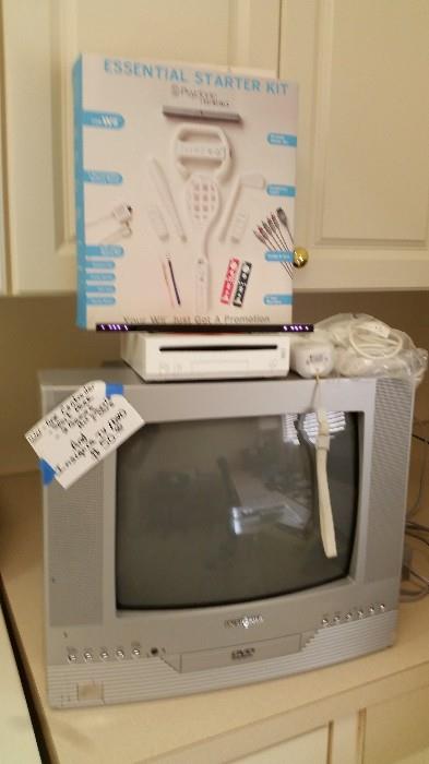 Wii console and small TV plus 2 games and sport pack accessories