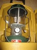 Vintage Coleman lantern with yellow clamshell carrying case