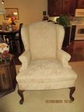 2 matching wing back chairs in neutral beige/tan solid floral print