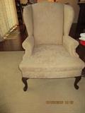 2 matching wing back chairs in neutral beige/tan solid floral print