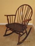 One of two antique/vintage wood rocking chairs