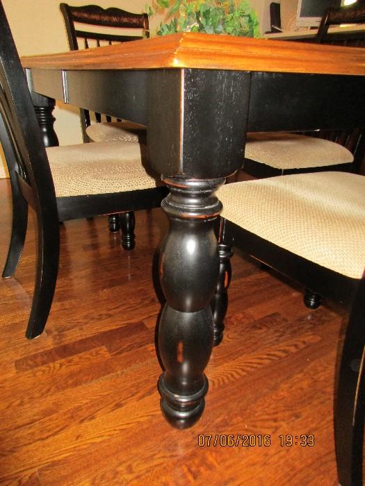 Black and wood table top, Kitchen table with turntable legs  and four upholstered chairs