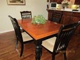Black and wood table top, Kitchen table with turntable legs  and four upholstered chairs