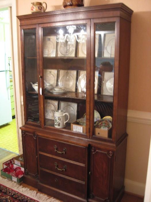 White Furniture Company solid mahogany china cabinet with signed Lalique plates and more.
