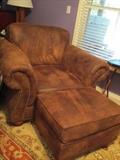 2 matching leather chairs and ottomans
