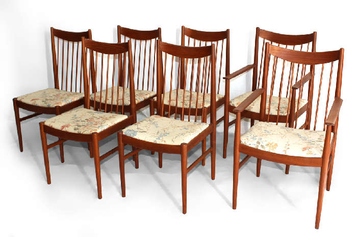 Lot 144:  ARNE VODDER FOR SIBAST SET OF 7 DINING CHAIRS: Danish Modern teak spindle back chairs, 2 arm chairs and 5 side chairs. Later fabric on the seats. Danish control button and Sibast Furniture label. Arm chairs are 38 1/2'' x 20 1/4'' x 20 1/4''.
