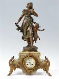 Lot 14:  FRENCH FIGURAL BRONZE AND GREEN ONYX MANTLE CLOCK: Patinated metal figure of woman and cupid after Auguste Moreau finial title ''Le Reve''. Green onyx case with gilt metal mounts and feet. Porcelain dial with hand painted decoration. French A. D. Mougin time and strike movement. Key and pendulum in office. 25'' h x 14'' x 9''
CONDITION: Loss of gilt and finish on metal, currently running however not guaranteed to continue.