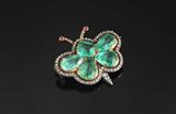 Lot 22:  AN ANTIQUE EDWARDIAN EMERALD, DIAMOND & RUBY MOTH FORM PIN: 14K yellow gold and sterling silver foil setting. The moth wings and head are 5 pear and emerald native cut emeralds believed to be of the muzo mine. Emerald weight totals approx. 4.85 Ct., are rated VS in clarity and 3-4 saturation. The 75 rose cut diamonds total approx. .25 Ct., VS-SI clarity and I-J color. The antenna are 2 round native cut rubies. Stones are gypsy and prong set. Bar pin closure. In the original presentation box. Width: 1 1/8''. Weight: 9.2 grams. Sold with current Atlanta Gemological's GIA graduate gemologist appraisal for $10,000. Est. $6000/10000**