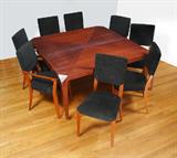 Lot 48:  NICOLE MILLER FOR EXCELSIOR DESIGNER FURNITURE: Fine Italian designer furniture. Square dining table and 10 chairs, 2 having arms. High glass Brandy Ribbon mahogany, tapered legs capped with brushed stainless steel. The table measures approx. 30'' high x 58'' square.