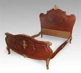 Lot 73:  FRANCOIS LINKE QUALITY FRENCH ORMOLU BED: Carved and shaped head board and foot board with applied ormolu decoration, foot board with additional foliate and arrow decoration. Head board 64 1/2'' h. x 67'' x 4'', foot 33'' x 67'', rails 76 1/2'' l.
CONDITION: Missing small piece of decoration on one bed rail, missing piece of carving on side of foot board.