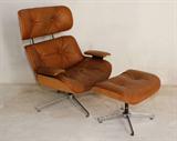 Lot 154:  PLYCRAFT EAMES TYPE LEATHER LOUNGE CHAIR AND OTTOMAN: Tufted leather on bent wood frame. Approx. 39''h. x 33'' x 26''. Ottoman is 15''h.