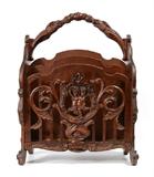 Lot 20: FIGURAL CARVED VICTORIAN CANTERBURY: Handle with figural eagle heads, sides with figural putti and foliate scroll, sides with applied masquerons and foliate scroll. 4 divided sections for magazines. Measures 26 1/2'' h. x 20'' x 13 3/4''.
