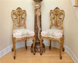 Lot 1020:  PR 19TH CENTURY DIENST SIGNED FRENCH CARVED SIDE CHAIRS: Carved and gilded frames in the rococo style, striped and floral upholstery. Shaped back, skirt and legs. Original ''Dienst, 66 Fgb, St. Antoine, Paris'' label attached to bottom of seat. 36 1/2'' h. x 17'' x 17''.
CONDITION: Loss of gilt, age separations, small missing piece on one back. Please call for condition.