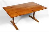 Lot 1096:  19TH CENTURY PINE TRESTLE TABLE: Pine trestle table with original breadboard top on spool turned legs, base with through tenon construction terminating in shoe feet. Ca 1860. 29'' h. x 62'' x 40''