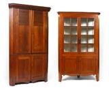 Lot 1137:  LARGE 19TH CENTURY CORNER CABINET: Top with 2 wood doors and 3 shelves over lower 2 doors with single shelf. Shaped skirt. Measures 84'' h. x 50'' x 18 1/4''.
CONDITION: Wear consistent with age and use.Lot 1136:  19TH CENTURY CHERRY CORNER CABINET: Straight conice top section with 16 light doors and 3 interior shelves over lower 2 doors with single shelf. Painted interior, shaped skirt. Original panel back with square and round nails. Measures 83 1/2'' h. x 54'' x 19 1/2''.
CONDITION: Wear consistent with age and use. One glass has a bubble imperfection.