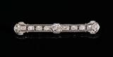 Lot 1014:  A FINE PLATINUM FILIGREE DIAMOND BAR PIN: Centering an approx. .85 Ct old European cut diamond of VS1 clarity and I color. The additional diamonds of the same type cut total 1.80 Ct., VS clarity, H-I color. TOTAL diamond weight: 2.65 Ct. Length: 2 5/8''. Weight: 8.3 grams. Sold with current Florida Diamond Appraisers GIA graduates appraisal for $11,550.