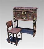 Lot 1048:  CARVED VARGUENO DESK: Tack and painted leather top, carved styles with fish scale and foliate motifs, fall front desk with decorative hinges. Front with carved shield and painted rampant lion, painted cavaliers on either side. Architectural galleries on pigeon holes, 2 internal drawers. Barley twist supports, block stretchers, carved front feet. Overall measures 50 1/4'' h. x 41 3/4'' x 18 1/2''. Sold with matching tacked leather upholstered chair with barley twist front legs and stretchers, 33'' h. x 19'' x 16 3/4''.
CONDITION: Wear and tears to leather, other wear consistent with age and use.