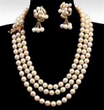Lot 1082:  TRIPLE STRAND PEARL NECKLACE WITH ORNATE DIAMOND CLASP AND EARRINGS: Three strand necklace of 6.50-7.00 mm cultured pearls, 18'' overall, with a 14K gold clasp with round single cut diamonds. 14k yellow gold earrings have clusters of 4.00-6.00 mm cultured pearls. Clip closures on earrings. Gold weight: 15.0 grams approx.