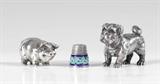Lot 1095:  3 PIECE RUSSIAN SILVER BULLDOG, PIG, AND THIMBLE: To include 1) Bulldog with amethyst eyes, marks for Julius Rappoport, 88 zolotnik. 1 1/2'' h. 2) Pig with amethyst eyes, marks for Julius Rappoport, Moscow 88 zolotnik. 1 1/8'' h. 3) Thimble with enamel foliate scroll collar, stamped 84. All 3 sold as possibly spuriously marked. Approx. 9.8 troy oz.