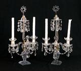 Lot 1128:  PAIR GEORGIAN CRYSTAL CANDLEABRA: Each with star finial over prism drops, cut glass shaft. 2 arms ending in bobeches for candles, third arm with final. Each arm with drop prisms and garland swag between arms. Over cut glass bodies, stepped base. Overall measures 23 1/4'' h. x 12 3/4'' x 6''.
CONDITION: Condition issues exist, please call for condition.