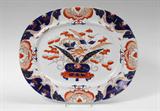 Lot 1139:  MASON'S IRONSTONE PLATTER: Flora and urn motif center, marked Mason's Patent Ironstone China. 17 1/4'' x 14''.