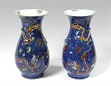 Lot 1162:  PAIR ORIENTAL DRAGON VASES: Blue ground with enamel floral and dragon motifs, applied gilt dragon encircling neck. White glaze interior with flowers. Unmarked, actual age unknown. Measure 14 1/8'' h. x 7 1/2''.
CONDITION: One with cracks at rim and neck, both with missing gilt and enamel.