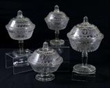 Lot 1315:  4 EAPG MINERVA COVERED COMPOTES: 19th C. glass compotes in the Minerva patter. Covered bowls on tall stems, range in size from 11-9'' tall and 6-8'' dia.