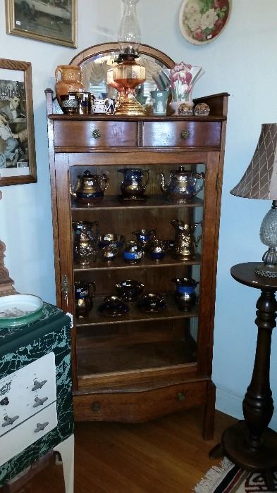 One of many antique curio cabinets.  Antique Lusterware.