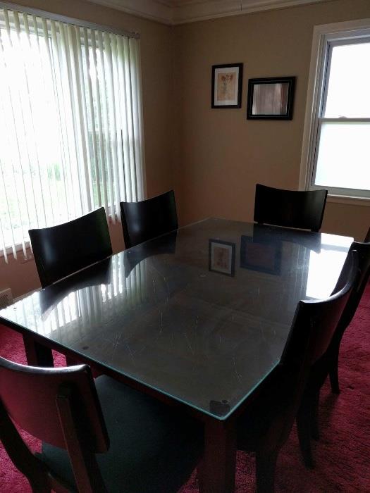 Glass on top of solid wood table with 6 chairs and a leaf!