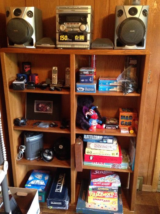Games and stereo equipment, wood bookcase and fans.