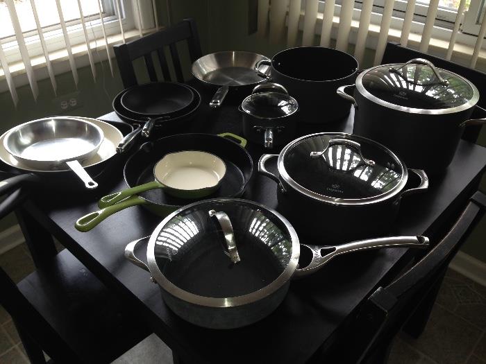 Cookware on top of a Table with 4 chairs.