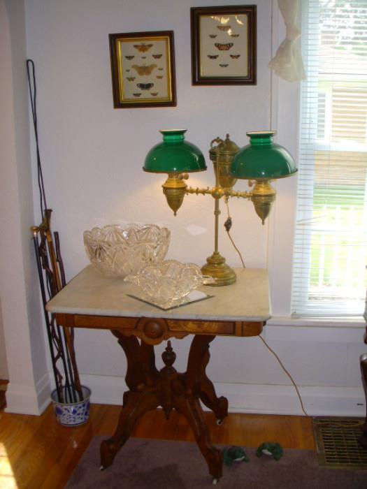 Canes in corner, one with gold-filled knob; American walnut marble top table.  Double Student oil lamp (electrified) has "E M" on it for Edward Miller. 