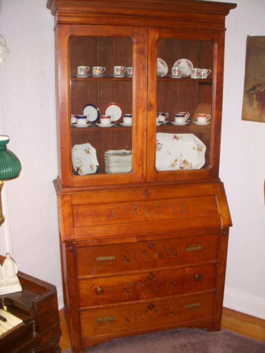 Cherry finish secretary with tiger panel on drop-front desk, spoon carving.  Note: replaced knobs on middle drawer
