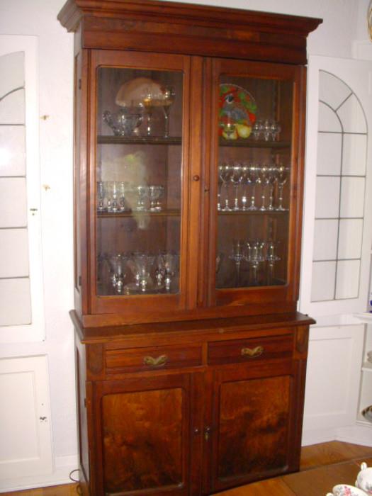 American walnut step-back cupboard displaying stemware.  Cupboard dates to late 19th century.