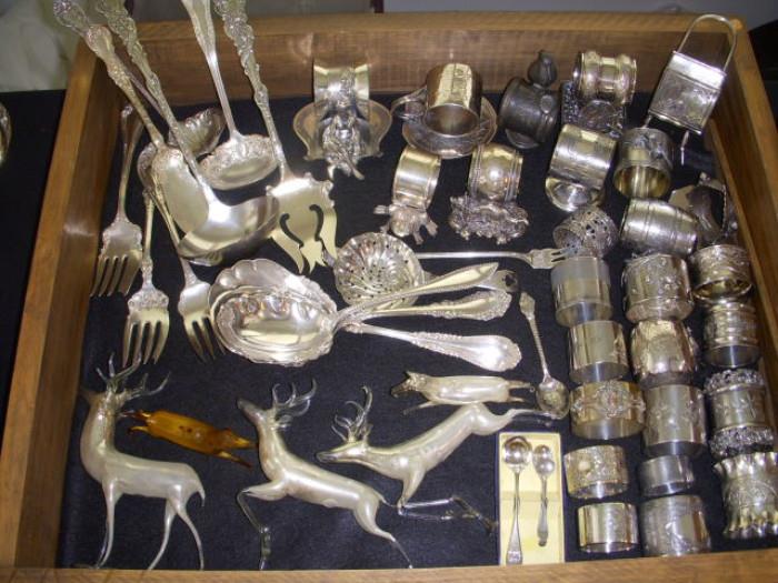 Silverplate serving pieces and a LOT of napkin rings.  Lower left are blown mercury glass deer...3 standing and 2 designed as ornaments.  A couple retain the "Made in Germany" paper labels