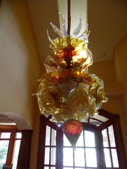 WOW! This stunning chandelier, titled "Golden Sun Chandelier" was created by artist Michael Roco. His gallery is located in Naples, FL. Here is link to his website: http://www.michaelmarceloroco.com/chandeliers-2 Owner said It is VERY easy to deal with, it is in 50-60 pieces that owner puts in the dishwasher to clean! Owners paid just under $20,000 for this gorgeous piece and we're selling it for $7500. Home is located in Champaign and owners will pay for shipping if needed. No tax! Please contact Whitney 2176496288 text/call with any questions and interest! Beautiful!