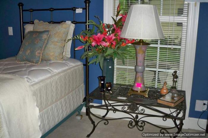 One of pair twin beds, Wildwood lamp, wrought iron coffee table