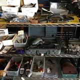 Nail gun in case, BMW motorcycle parts, bins of shop supplies