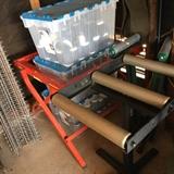 Bosch folding toll table, same as shown with saw in previous photo and bins of bottles, also cool old grate style racks/shelves