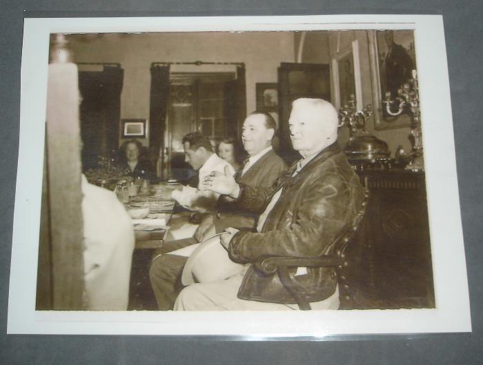 Photograph of John Nance Garner sitting in front of sideboard
