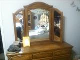Queen Size Solid Oak Bedroom Suit. Set includes: Head and Foot Boards, Dresser w/Mirror and Chest